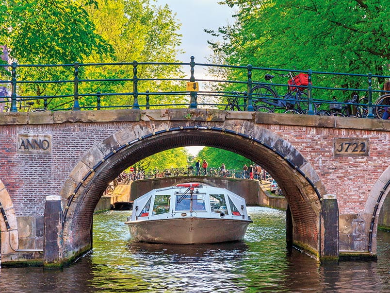 A boat sailing on the canals in Amsterdam, Netherlands